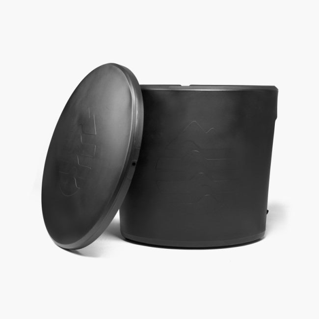 the ice barrel of cold plunges sits with its lid off on a white background