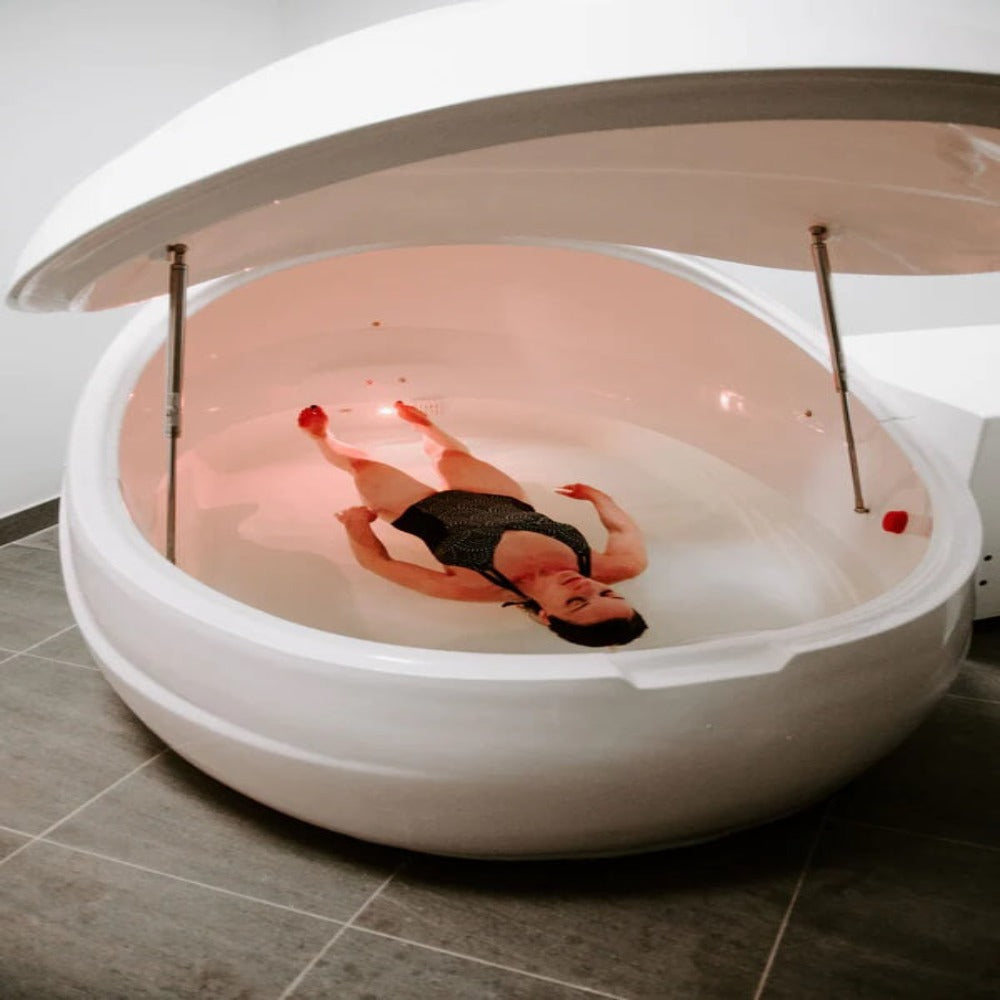 A lady Floating In A Dreampod V2 Float Pod