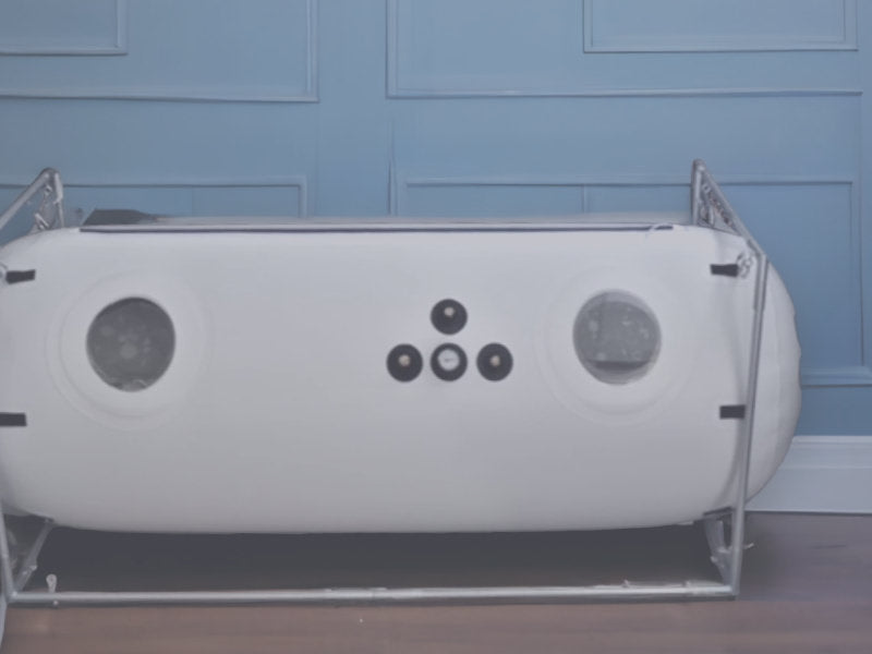 Newtowne Hyperbaric Chamber sits against a blue wall in an chic room