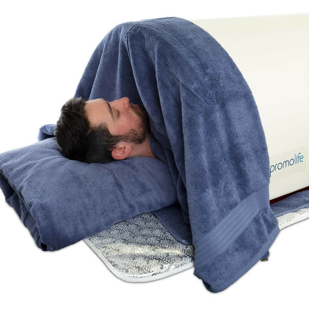 A man in An Ozone Ready Far Infrared Sauna Dome With Towel Strap