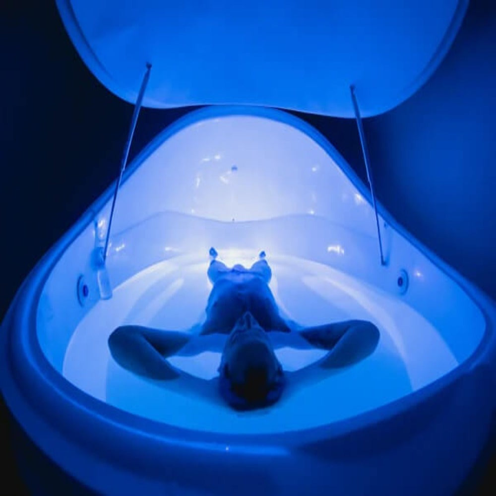 Relaxed Man In A Dreampod Vmax Float Pod With Blue Light