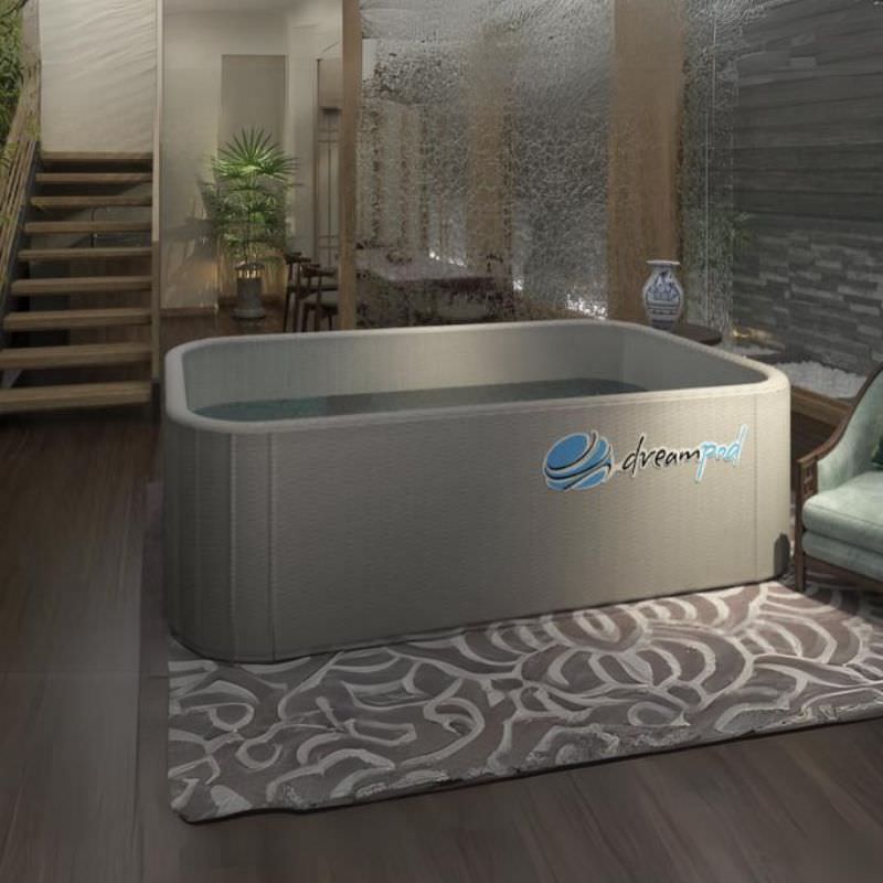 the dreampod home float flex sits in a beautiful room. The float tank is inflated and filled with water.