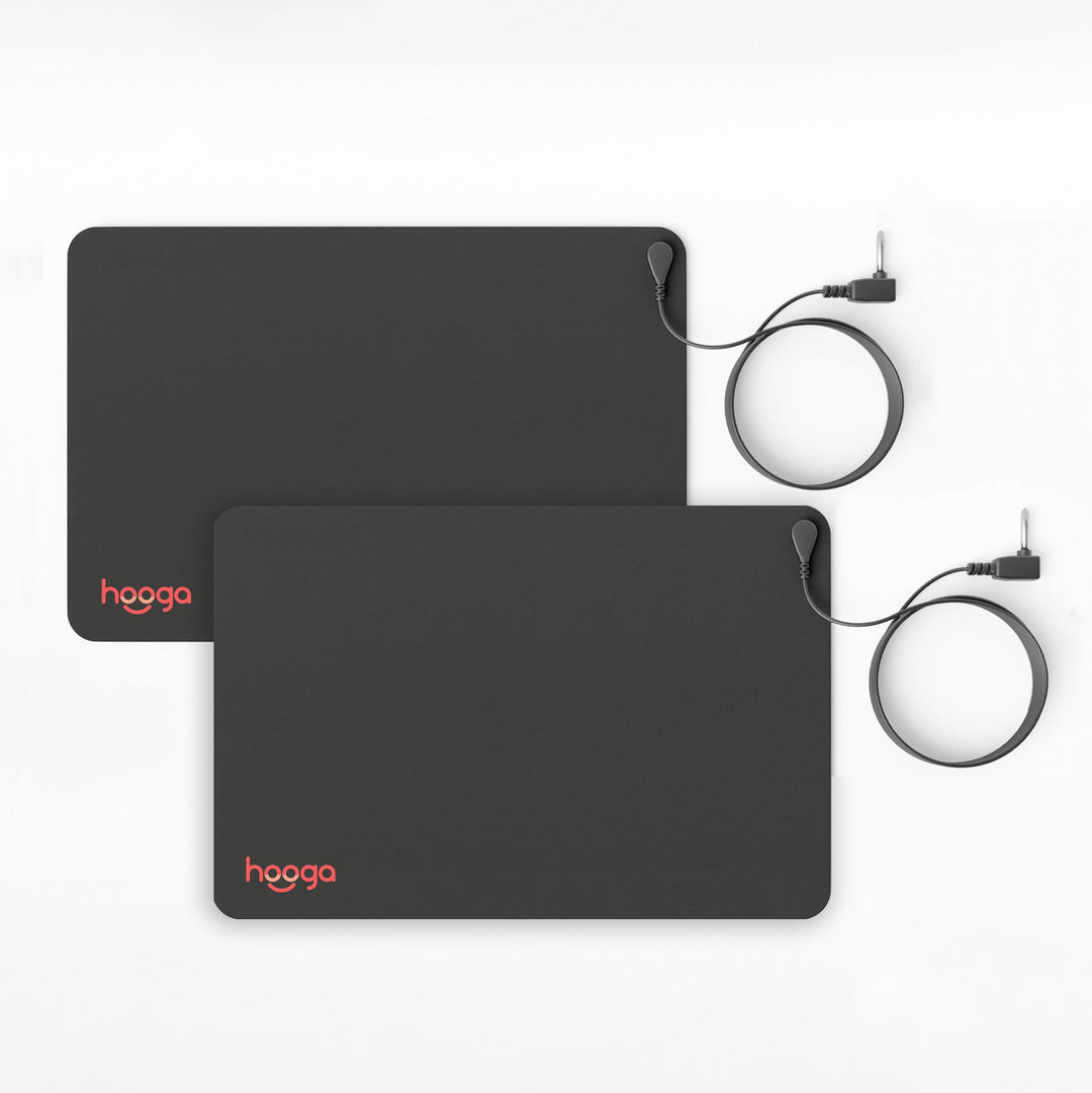 Two Hooga grounding mats laid flat side by side with grounding cords
