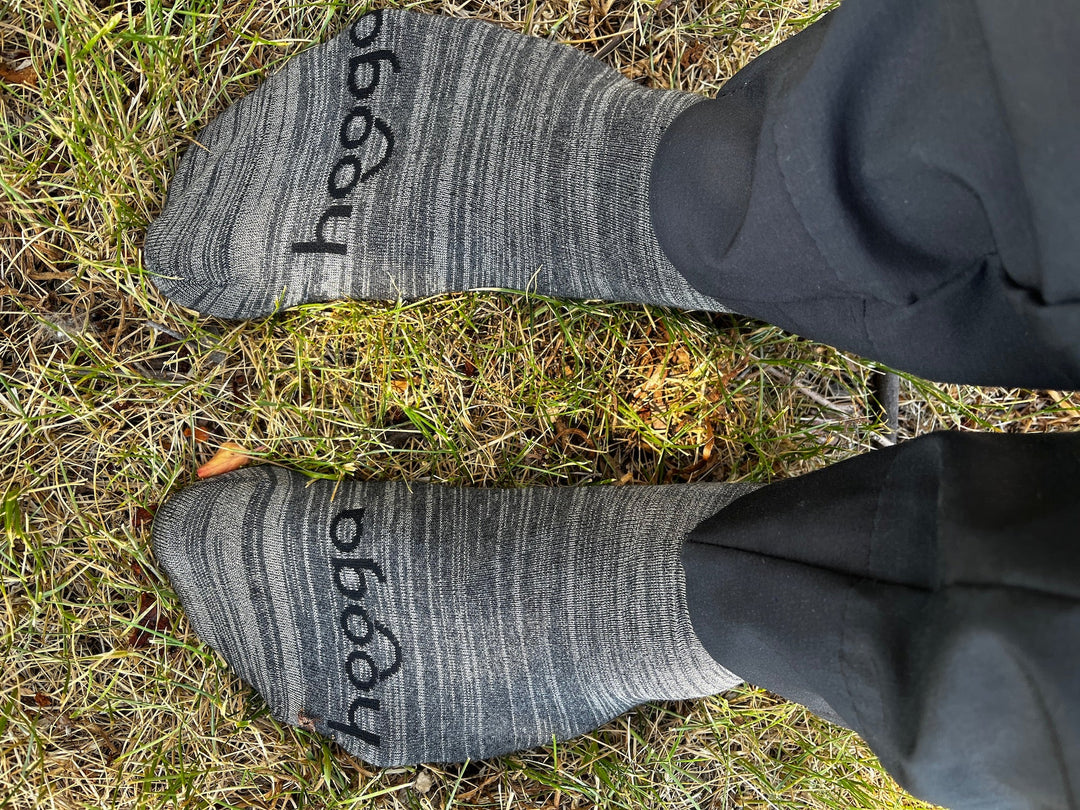 Person wearing Hooga grounding socks with cord connected, lifestyle photo