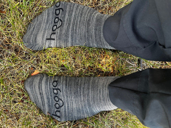 Person wearing Hooga grounding socks with cord connected, lifestyle photo