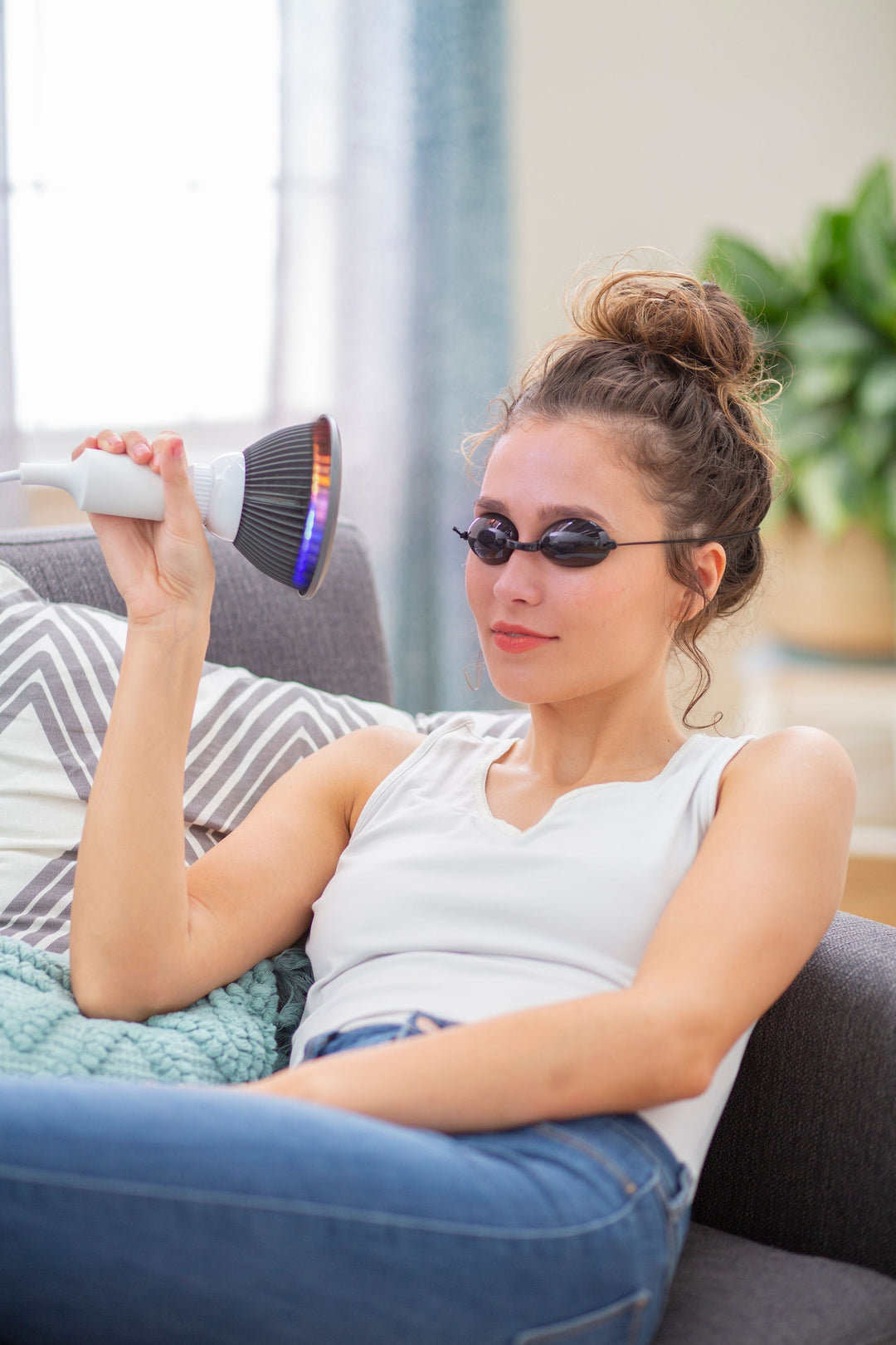 Person holding the Hooga HG24 4-in-1 light therapy bulb near their face