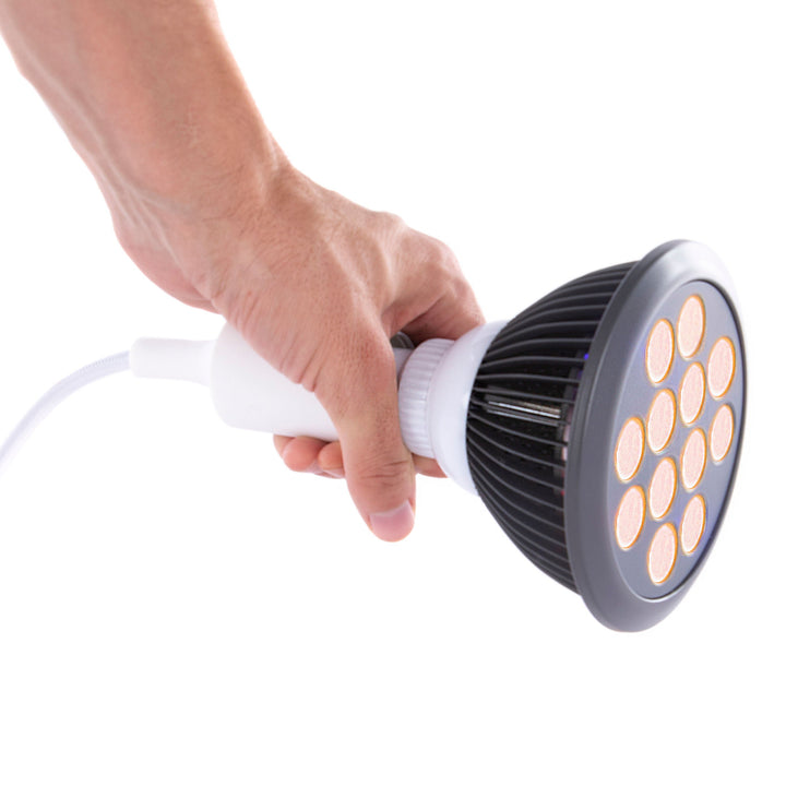 Hand holding the Hooga HG24 orange LED light therapy bulb