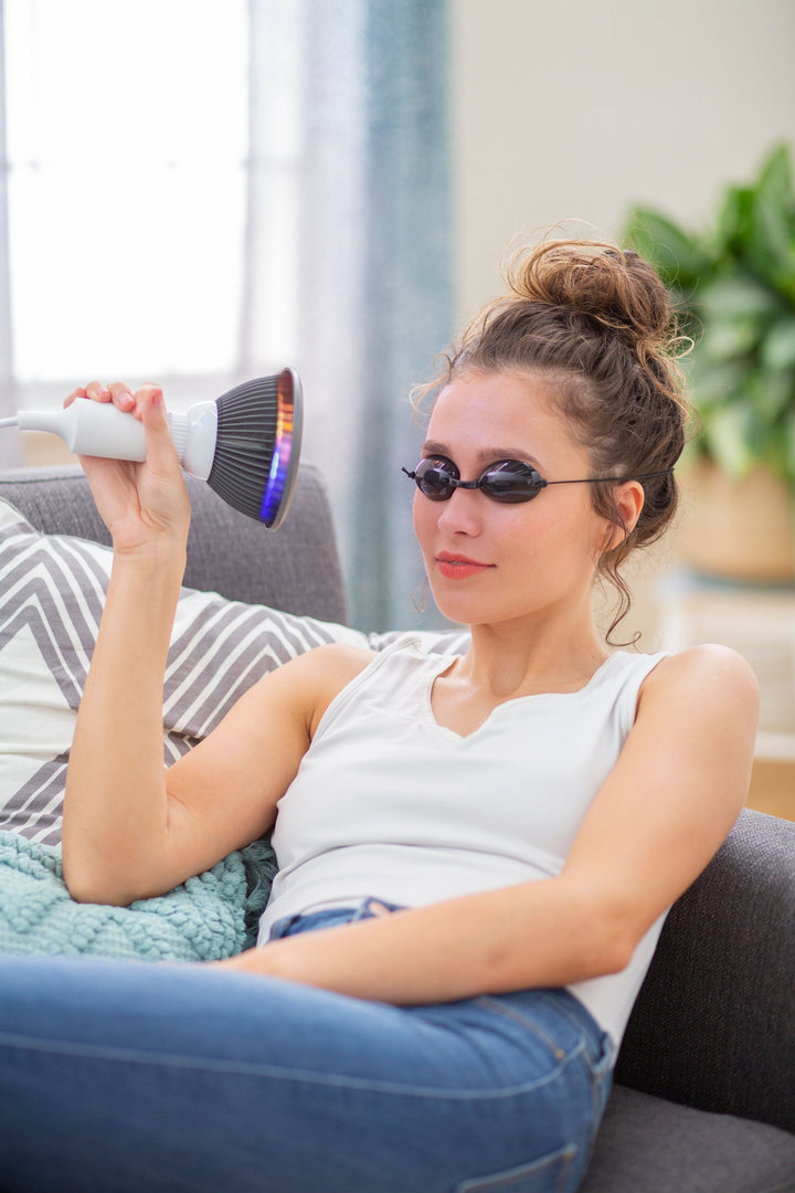 Person holding the Hooga HG24 orange LED light therapy bulb near their face