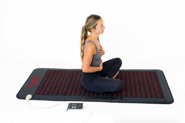 Person lying on the Hooga PEMF Mat with Infrared Heat during a full-body session
