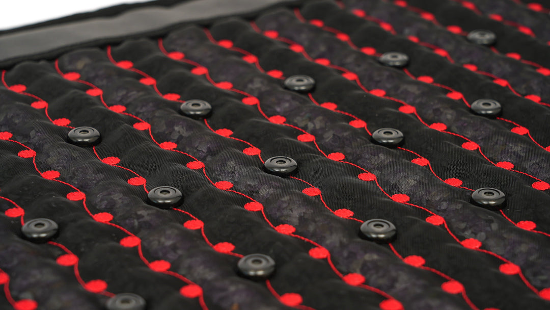 Angled close-up of PEMF coils and red LEDs woven through the Hooga Red Light PEMF Mat