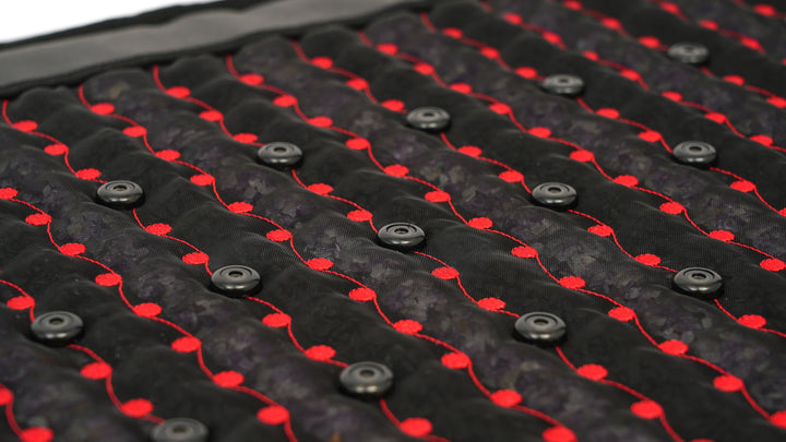 Angled close-up of PEMF coils and red LEDs woven through the Hooga Red Light PEMF Mat