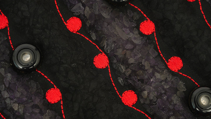 Close-up texture of the Hooga Red Light PEMF Mat mesh cover and embroidered pattern
