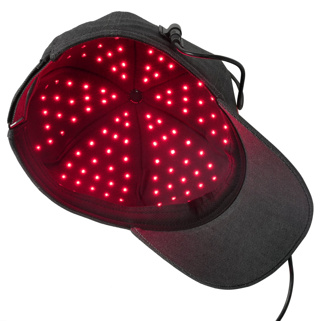 Underside of the Hooga red light therapy hat with red LEDs illuminated inside