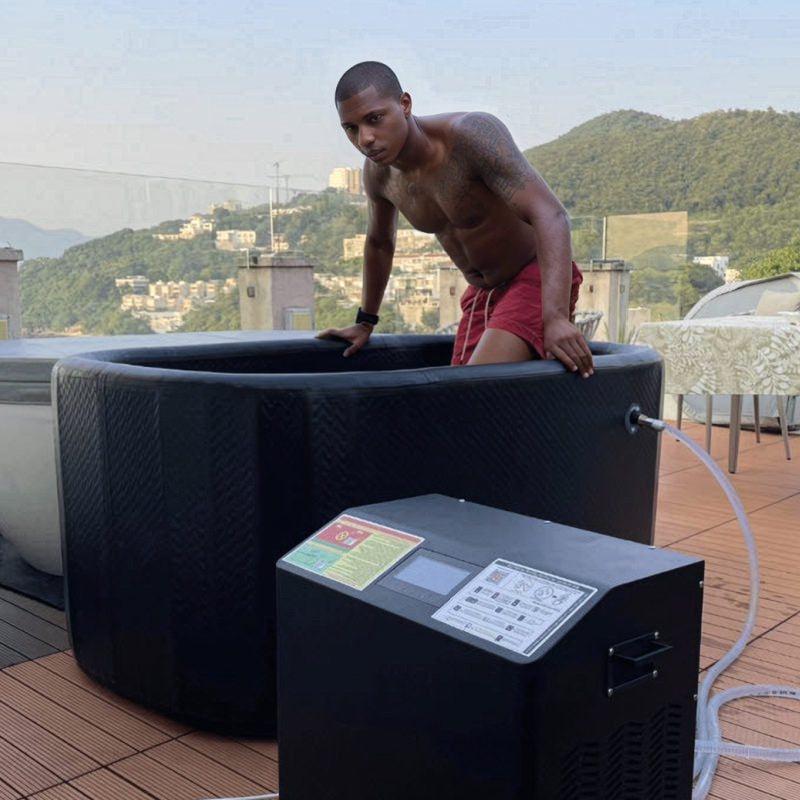 a man climbs into an inflated ice bath flex. The engine sits in the foreground.